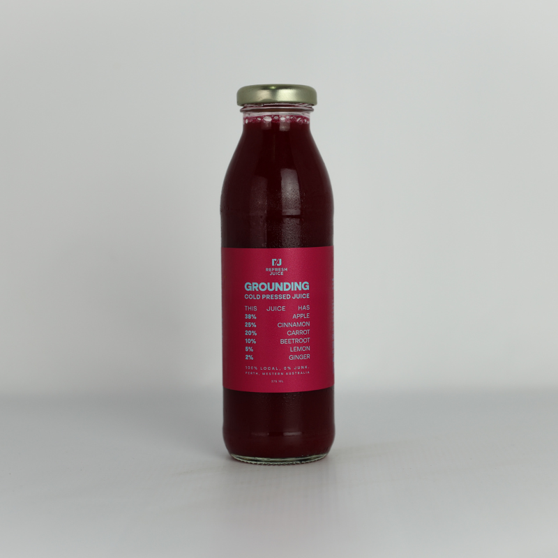 Grounding cold-pressed juice blend in a glass bottle with Beetroot Ginger and Lemon